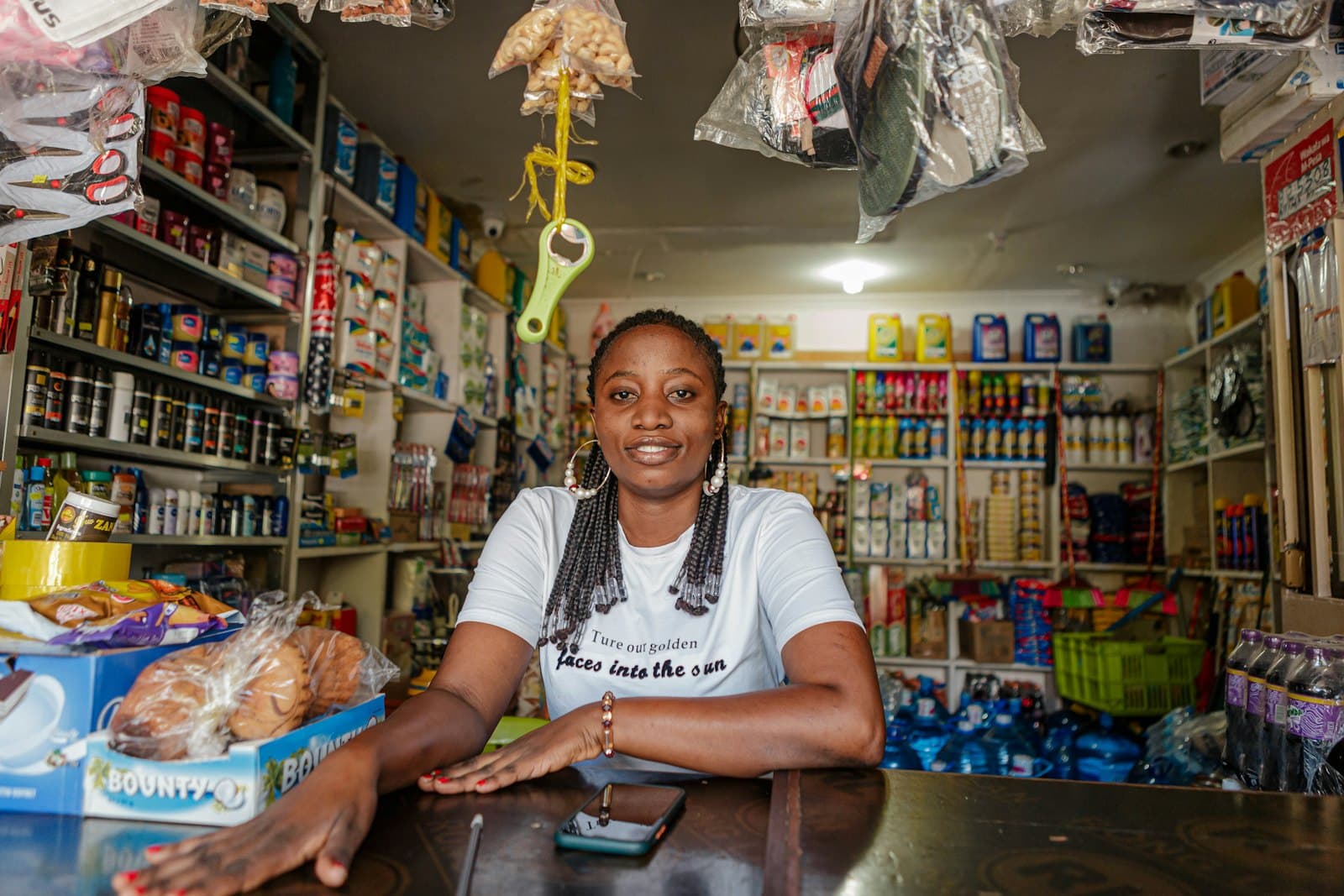 A shop owner standing behind the counter of her small business